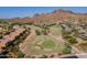 Picturesque aerial image displays the community golf course and home with views of the mountains at 5370 S Desert Dawn Dr # 30, Gold Canyon, AZ 85118