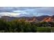 Picturesque view of a home on a golf course, surrounded by lush greenery and majestic mountains at 5370 S Desert Dawn Dr # 30, Gold Canyon, AZ 85118