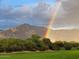 Scenic landscape featuring a vibrant rainbow arcing over lush greenery and majestic mountains at 5370 S Desert Dawn Dr # 30, Gold Canyon, AZ 85118