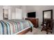 Cozy bedroom featuring a comfortable queen bed, dresser with TV, mirror, and neutral decor at 5370 S Desert Dawn Dr # 30, Gold Canyon, AZ 85118