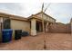 Spacious backyard featuring gravel, covered patio, and privacy fence at 5415 E Mckellips Rd # 104, Mesa, AZ 85215