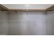 A simple closet with white walls and a wooden clothing rod for hanging items at 5415 E Mckellips Rd # 104, Mesa, AZ 85215