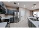 Bright kitchen featuring stainless steel refrigerator and appliances and stone countertops at 5415 E Mckellips Rd # 104, Mesa, AZ 85215