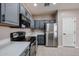 Stylish kitchen featuring gray cabinets, stainless steel appliances, and white countertops at 5415 E Mckellips Rd # 104, Mesa, AZ 85215