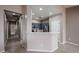 View of the kitchen from the living room with gray cabinets, stainless steel appliances at 5415 E Mckellips Rd # 104, Mesa, AZ 85215