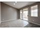 Bright living area with a ceiling fan, large windows, a built-in niche, and sliding glass doors at 5415 E Mckellips Rd # 104, Mesa, AZ 85215