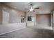 Open-concept living area showcasing neutral tones, a ceiling fan, large windows, and natural light at 5415 E Mckellips Rd # 104, Mesa, AZ 85215