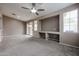 Bright living area with a ceiling fan, large windows, a built-in niche, and sliding glass doors at 5415 E Mckellips Rd # 104, Mesa, AZ 85215