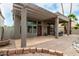This backyard features a covered patio, gravel landscaping, and desert foliage at 6014 E Sayan Cir, Mesa, AZ 85215