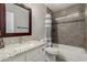 This bathroom features granite counters, a dark framed mirror, and tile surround at 6014 E Sayan Cir, Mesa, AZ 85215