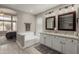 Primary bathroom features a soaking tub, tile floors, and dual sink vanity at 6014 E Sayan Cir, Mesa, AZ 85215