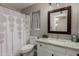 This bathroom features a granite countertop, framed mirror, and patterned shower curtain at 6014 E Sayan Cir, Mesa, AZ 85215