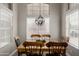 Bright dining room with decorative chandelier, views, and seating for six at 6014 E Sayan Cir, Mesa, AZ 85215