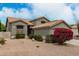 View of the home exterior showing desert landscaping, a two-car garage and a tile roof at 6014 E Sayan Cir, Mesa, AZ 85215