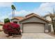 Charming single-Gathering home featuring desert landscaping, a two-car garage and a tile roof at 6014 E Sayan Cir, Mesa, AZ 85215
