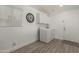 This laundry room features white cabinets, a washer and dryer, and wood-look floors at 6014 E Sayan Cir, Mesa, AZ 85215