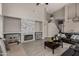 Open-concept living room with a cozy fireplace, comfortable seating, and wood-look floors at 6014 E Sayan Cir, Mesa, AZ 85215