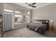 Spacious primary bedroom with backyard views, a ceiling fan, and carpet floors at 6014 E Sayan Cir, Mesa, AZ 85215