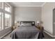 Cozy primary bedroom with soft carpet, a large window, and bedside lamps at 6014 E Sayan Cir, Mesa, AZ 85215