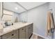 Bathroom featuring gray cabinets, granite countertops, and modern fixtures at 6029 W Pershing Ave, Glendale, AZ 85304