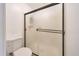 Bathroom featuring a toilet and a shower with modern glass doors at 6029 W Pershing Ave, Glendale, AZ 85304