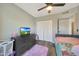 Bright bedroom with a fan, closet, dresser, and colorful bed at 6029 W Pershing Ave, Glendale, AZ 85304