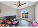 Bedroom with gray walls, dark-colored furniture, fan and ample window light at 6029 W Pershing Ave, Glendale, AZ 85304