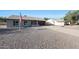 Single-story brick home with an American flag, a long driveway, and a low-maintenance rock yard at 6029 W Pershing Ave, Glendale, AZ 85304