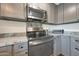 Detailed view of a kitchen featuring stainless steel appliances and light granite countertops for modern cooking at 6029 W Pershing Ave, Glendale, AZ 85304