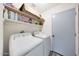 Functional laundry room with washer, dryer, and shelving for supplies, making laundry tasks simple at 6029 W Pershing Ave, Glendale, AZ 85304