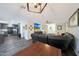 Inviting living room with modern decor, gray floors, and a mounted television for relaxing or entertaining guests at 6029 W Pershing Ave, Glendale, AZ 85304