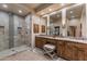 Bathroom featuring double vanity, stone countertops, large framed mirrors, and tiled walk-in shower at 6888 E Mighty Saguaro Way, Scottsdale, AZ 85266
