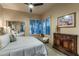 Comfortable bedroom features bright windows, ceiling fan, and mirrored closet at 6888 E Mighty Saguaro Way, Scottsdale, AZ 85266