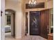Inviting foyer with elegant chandelier and view to bedroom and front porch at 6888 E Mighty Saguaro Way, Scottsdale, AZ 85266