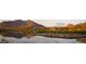 Scenic view of the Terravita golf course, featuring a serene lake, manicured greens, and mountain views at 6888 E Mighty Saguaro Way, Scottsdale, AZ 85266