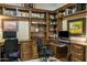 Well-organized home office with custom shelving and ample desk space at 6888 E Mighty Saguaro Way, Scottsdale, AZ 85266