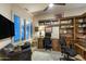 Spacious home office with custom built-ins, comfortable seating, and bright light at 6888 E Mighty Saguaro Way, Scottsdale, AZ 85266