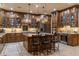 Gourmet kitchen with island, wooden cabinets, granite countertops, and stainless steel appliances at 6888 E Mighty Saguaro Way, Scottsdale, AZ 85266