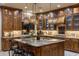 Spacious kitchen featuring custom wood cabinetry, granite countertops, and pendant lighting at 6888 E Mighty Saguaro Way, Scottsdale, AZ 85266