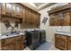 Large laundry room with plenty of cabinets and countertop space at 6888 E Mighty Saguaro Way, Scottsdale, AZ 85266