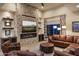 Living room features a fireplace, leather seating, and an accent wall at 6888 E Mighty Saguaro Way, Scottsdale, AZ 85266