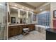 Main bathroom with a dual sink vanity, soaking tub, walk in shower, and decorative glass block window at 6888 E Mighty Saguaro Way, Scottsdale, AZ 85266