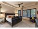 Relaxing main bedroom with a tray ceiling, large windows, and a ceiling fan at 6888 E Mighty Saguaro Way, Scottsdale, AZ 85266