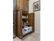 Custom wood pantry featuring pull out shelves for ease of use in the kitchen area of the home at 6888 E Mighty Saguaro Way, Scottsdale, AZ 85266