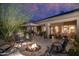 Outdoor patio with a fire pit, comfortable seating, and an outdoor cactus art piece at 6888 E Mighty Saguaro Way, Scottsdale, AZ 85266