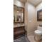 Elegant powder room with granite vanity, decorative mirror, and modern lighting at 6888 E Mighty Saguaro Way, Scottsdale, AZ 85266