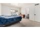 Cozy bedroom with large window, plantation shutters, and ensuite bathroom access and pool view at 7416 S Mcallister Ave, Tempe, AZ 85283