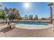 Backyard with blue pool and outdoor grill overlooking the golf course surrounded by trees at 7416 S Mcallister Ave, Tempe, AZ 85283