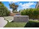 Outdoor kitchen area with built-in barbecue and expansive green lawn for entertaining at 7528 E Windrose Dr, Scottsdale, AZ 85260