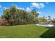 The yard features a lush lawn, mature landscaping, and pool making it perfect for outdoor living at 7528 E Windrose Dr, Scottsdale, AZ 85260